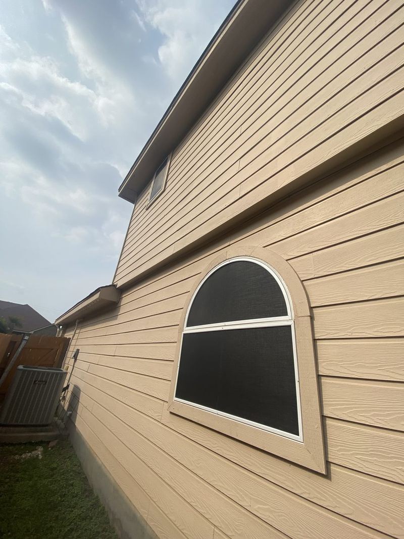 Custom shaped window solar screen on siding