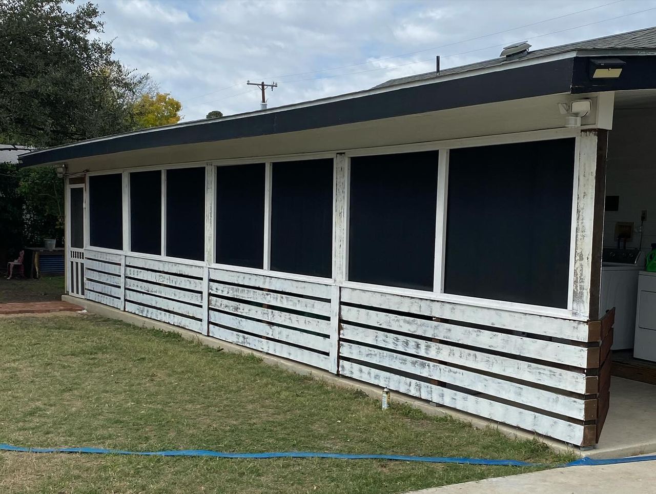 Long covered porch enclosed with black solar screen panels