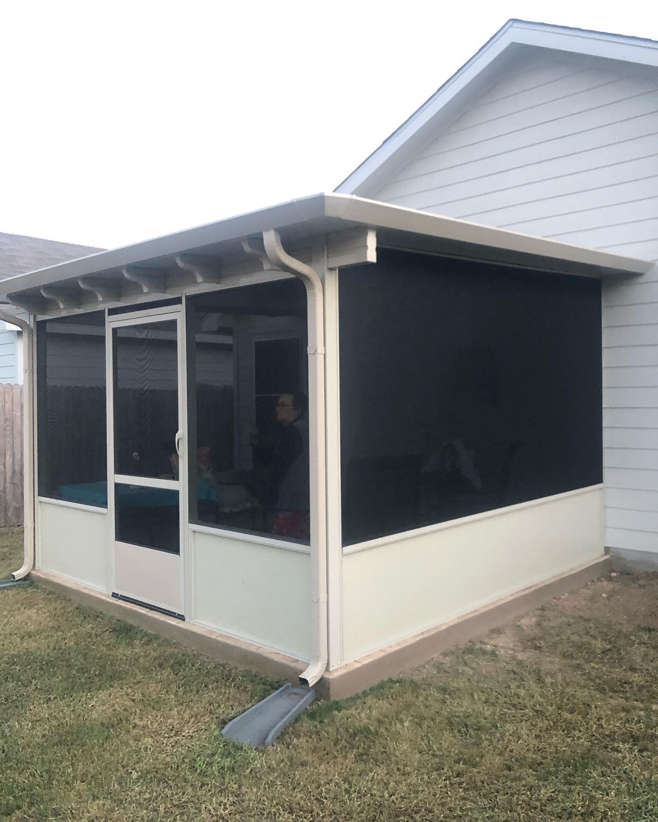 Patio enclosure with solar screens
